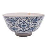 A large English blue and white delftware bowl: the exterior painted with stylised floral sprays and