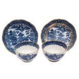 A pair of Caughley blue and white tea bowls and saucers: printed and gilded with the 'Pagoda'