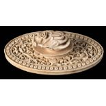 A Canton carved and reticulated ivory sewing accessory: of oval form carved with scrolling peony,