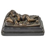 A 19th century bronze study of a sleeping putto: his head on a pillow and partially covered by a