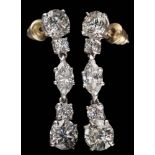 A pair of diamond pendant drop earrings: each with a lower brilliant-cut diamond drop of 1.