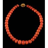 A coral bead single-string necklace on vacant-set clasp: approximately 58gms gross weight.