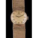 A lady's 9ct gold 'Tissot' wristwatch: the dial with baton makers and on mesh-link strap,