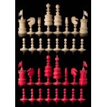 A 19th century bone Barleycorn pattern chess set: one side stained red, the other left natural,