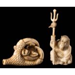 A Japanese carved ivory netsuke: depicting a monkey held within a bird's talons, signed, 4.5cm.