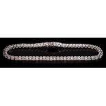 An 18ct white gold and diamond tennis bracelet: with 62 round brilliant-cut diamonds,