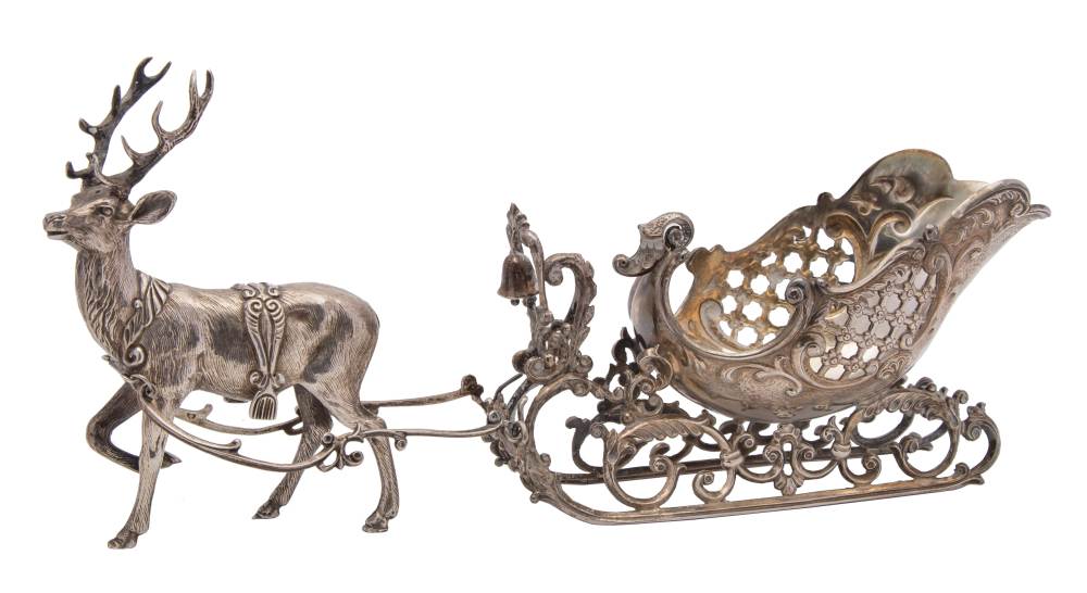 A Continental silver model of a reindeer pulling a sleigh,