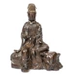 A Chinese bronze figure of Samantabhadra: seated on a recumbent elephant,