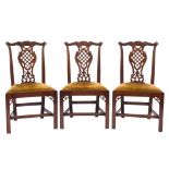 A set of six George III carved mahogany dining chairs:, in the Chippendale taste,