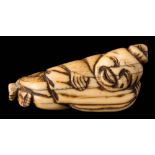 A Japanese carved ivory netsuke: depicting a laughing entertainer carrying a sack,