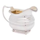 A George III silver milk jug, maker's mark worn, London,