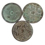 A Chinese bronze mirror: of archaic circular form decorated with mythical animals, 13cm.