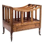 An early 19th Century mahogany three division canterbury:, with slatted uprights,