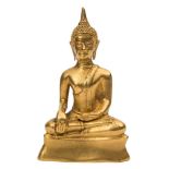 A gilt bronze figure of buddha shakyamuni: seated cross-legged,