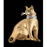 An emerald and diamond mounted 'cat' brooch: stamped '18K', the seated cat with prominent whiskers,