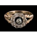 An antique diamond mounted circular cluster ring: with round old brilliant and brilliant-cut