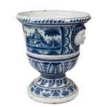 An impressive large French faience jardiniere: of campana form with female mask head handles,
