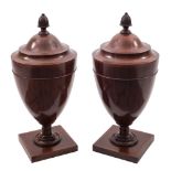 A pair of late 19th Century mahogany and inlaid cutlery urns in the Neo Classical taste:,