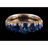 A late 19th century gold and sapphire five-stone half-hoop ring: the cushion-shaped sapphires