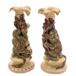Two Alexander Lauder (Barnstaple) pottery grotesque candlesticks: each modelled with a warty