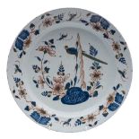 An English polychrome delftware dish: painted in blue, green and iron-red with a long-tailed bird,