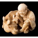A Japanese carved ivory netsuke: of a farmer seated with his oxen, signed Masayoshi, 3.5cm. wide.
