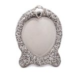 An Edward VII silver easel dressing table mirror, maker WC, London, 1909: of heart-shaped outline,