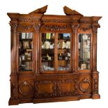 An 18th Century style carved mahogany breakfront library bookcase after the original by William