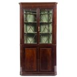 A 19th century mahogany standing corner display cabinet,: the upper part with a moulded cornice,