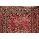 An Iranian carpet,: the wine field with a central arabesque floral medallion,