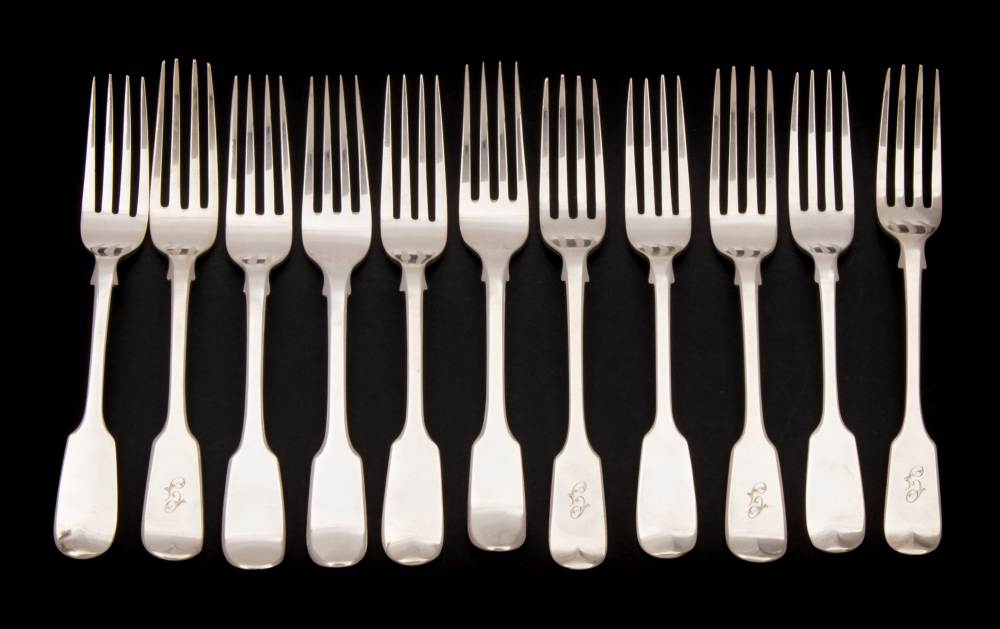 A collection of eleven silver Fiddle pattern dessert forks,