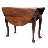 A mid 18th Century mahogany oval drop flap dining table:, with a hinged top on cabriole legs,