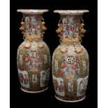 A pair of large Canton famille rose enamel baluster vases: with gilt double lion dog handles and