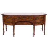 A 19th Century mahogany bow-fronted sideboard:, the top with a moulded edge,