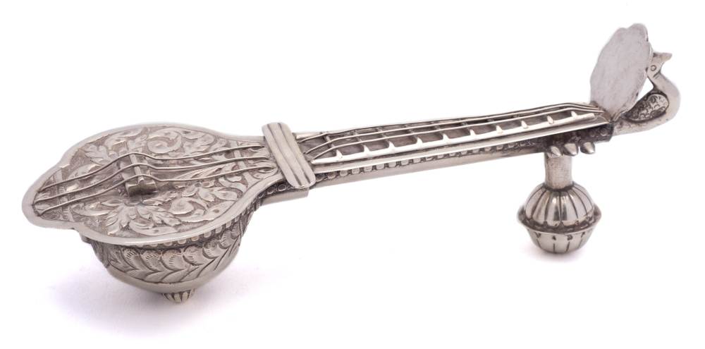 An Indian white metal pen stand in the form of a sitar: with hinged soundboard and finger board,