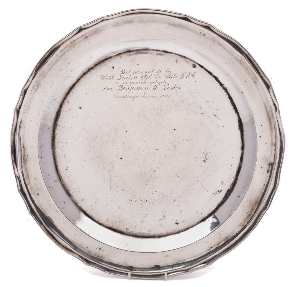 A large South American silver charger, stamped Chile, 900: inscribed, with a wavy-edge border, 45cm.