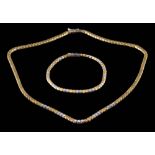 A diamond mounted two-tone necklace together with a matching bracelet: set with round,