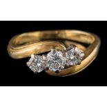 An 18ct gold and diamond three-stone cross-over ring: the round,