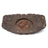 A Chinese bronze cup stand: of rounded rectangular form cast with taotie masks on a leiwen ground,