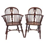 Two similar early 19th Century yew-wood and elm stick back Windsor elbow chairs:,