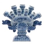 A Dutch blue and white delftware tulip vase: the body of arched flattened form with nine nozzles in