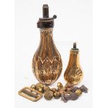 A 19th century copper powder flask: with embossed foliate decoration,