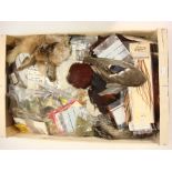 A collection of various fly tying equipment and accessories:, including a selection of feathers,