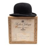 A black felt bowler hat by Austin Reed:, in an associated Herbert Johnson hat box, 60cm diameter.