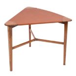 A coffee table of Scandinavian influence: the triangular imitation leather covered top with teak