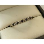 A 9ct gold sapphire and diamond half eternity ring.