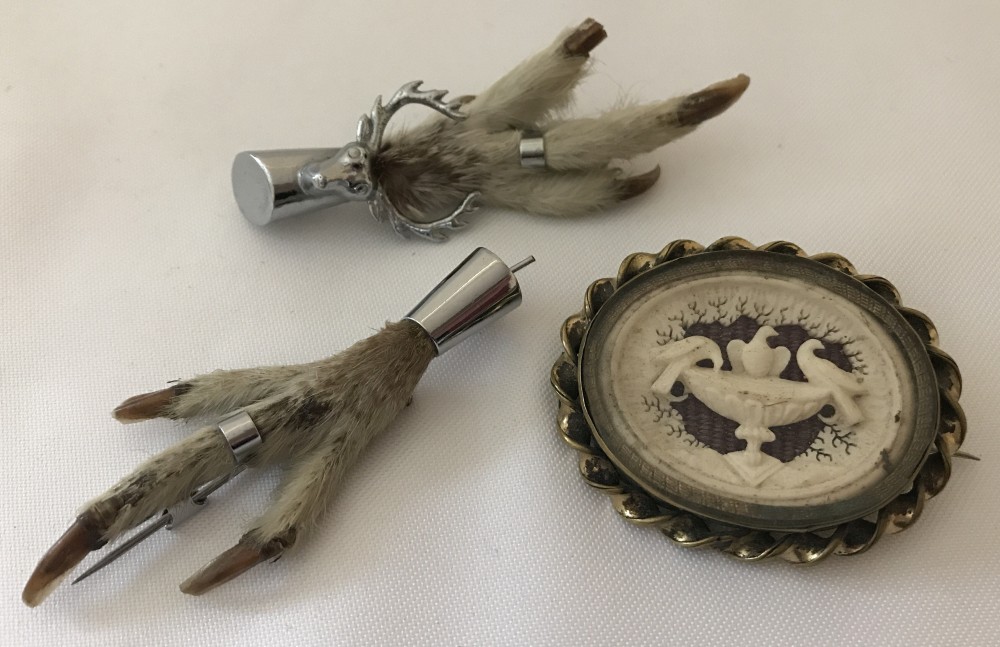 2 grouse feet Mizpah brooches, one with a stags head decoration.