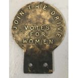 A reproduction brass "Votes for Women" suffragette car badge.