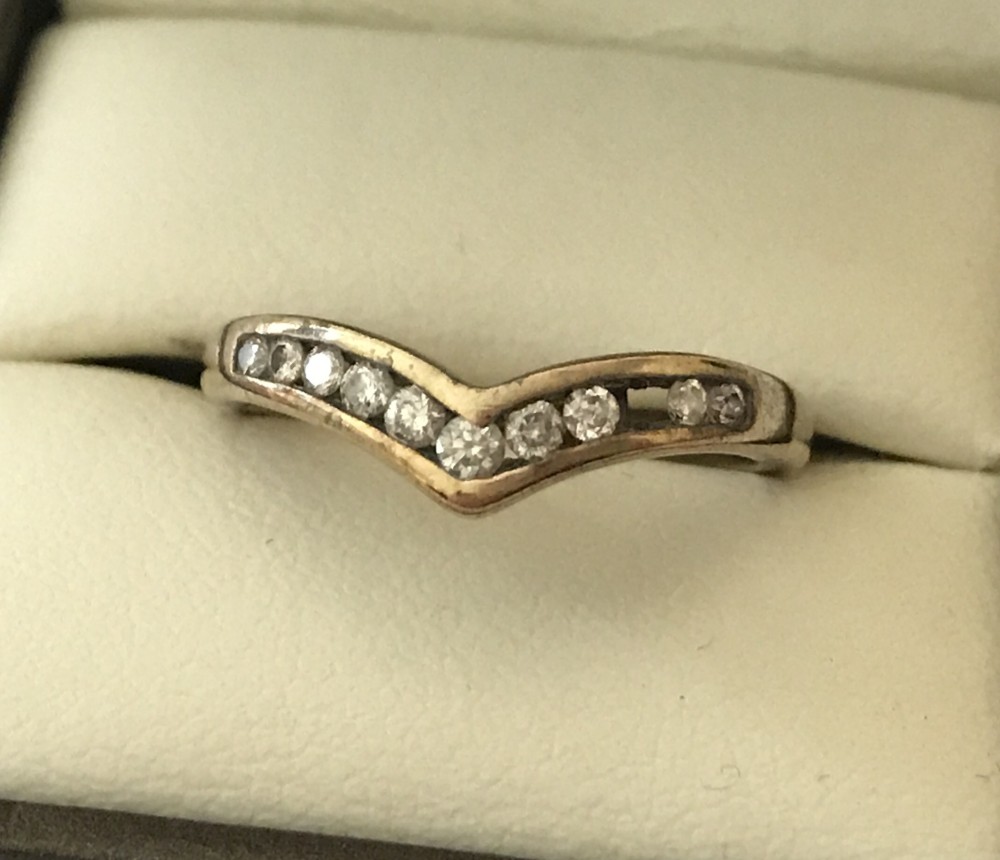 A ladies wishbone ring with .25ct channel set diamonds.