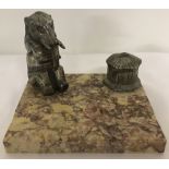 An Art Deco style marble based standish with metal elephant figure & basket shaped Inkwell.